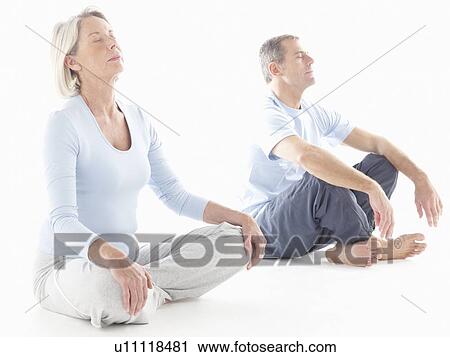 Stock Image - Mature couple doing yoga. Fotosearch