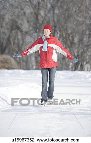 Stock Image - 13 year old girl skating, The Forks, Winnipeg, Canada. Fotosearch
