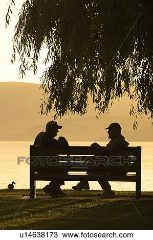 2 friends talking on a bench overlooking Lake Okanagan, Kelowna. BC View Large Photo Image Stock Image - 2 friends talking on a bench overlooking Lake Okanagan, Kelowna. BC. Fotosearch