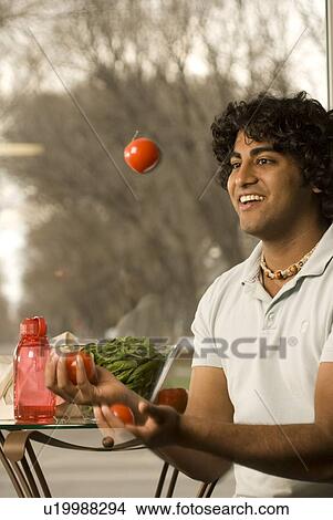 20 year old man holding juggling organic tomatoes, Brandon, Manitoba, Canada View Large Photo Image Picture - 20 year old man holding juggling organic tomatoes, Brandon, Manitoba, Canada. Fotosearch