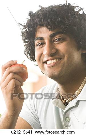 20 year old man holding organic apple, Brandon, Manitoba, Canada View Large Photo Image Stock Image - 20 year old man holding organic apple, Brandon, Manitoba, Canada. Fotosearch