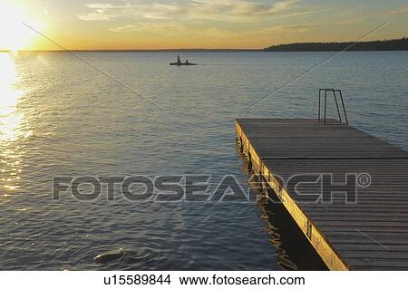 Picture - 45 year old woman Kayaking on Clear Lake; Canada, Manitoba, Riding Mountain National Park. Fotosearch