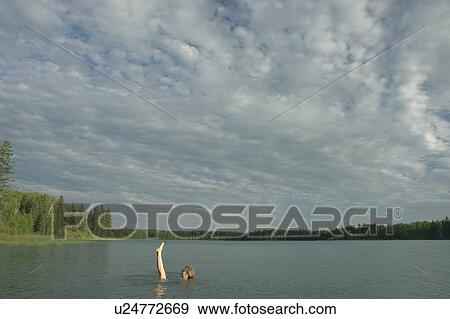 45 year old woman swimming in Katherine Lake. No motor boats allowed.; Canada, Manitoba, Riding Mountain National Park View Large Photo Image Stock Photo - 45 year old woman swimming in Katherine Lake. No motor boats allowed.; Canada, Manitoba, Riding Mountain National Park. Fotosearch