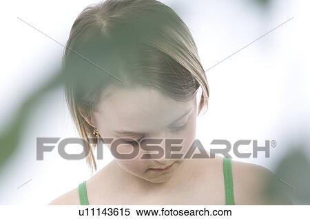 Stock Photography - 9 year old girl with the green leafs around her. Fotosearch