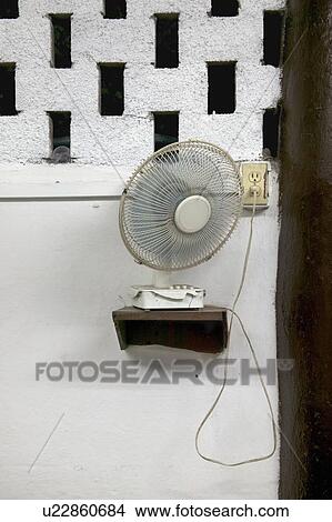 A fan sitting on a shelf, mounted on a wall, Cuba. View Large Photo Image Picture - A fan sitting on a shelf, mounted on a wall, Cuba.. Fotosearch
