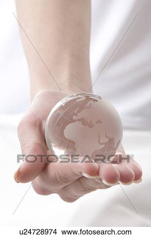 Picture - a hand with a globe. Fotosearch