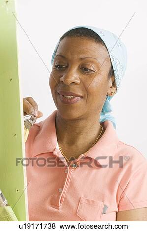 African American Woman Doing Home Improvement Painting, B. C. View Large Photo Image Stock Photo - African American Woman Doing Home Improvement Painting, B. C.. Fotosearch