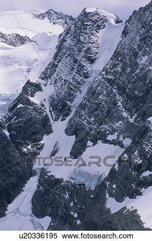 Alpine lake with glacier and mountains surrounding, Lake of the Hanging Glacier, East Kootenays, B. C. View Large Photo Image Stock Photography - Alpine lake with glacier and mountains surrounding, Lake of the Hanging Glacier, East Kootenays, B. C.. Fotosearch