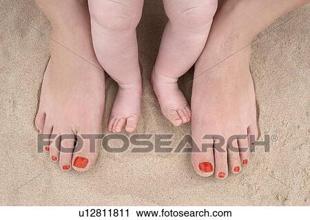 Baby feet and a Woman's feet at the Beach View Large Photo Image Stock Image - Baby feet and a Woman's feet at the Beach. Fotosearch
