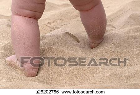 Stock Photograph - Baby feet walking on the Beach. Fotosearch