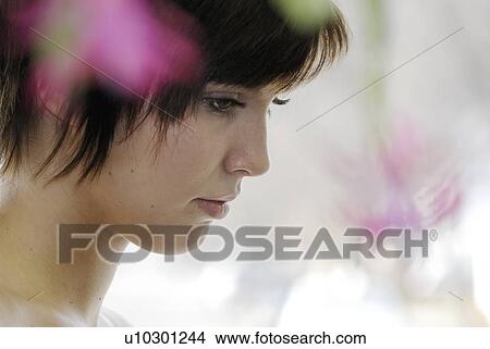 Cactus flower blurred in foreground of portrait of young woman, Canada, Manitoba, Brandon View Large Photo Image Picture - Cactus flower blurred in foreground of portrait of young woman, Canada, Manitoba, Brandon. Fotosearch