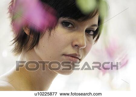 Cactus flower blurred in foreground of portrait of young woman, Canada, Manitoba, Brandon View Large Photo Image Stock Photo - Cactus flower blurred in foreground of portrait of young woman, Canada, Manitoba, Brandon. Fotosearch