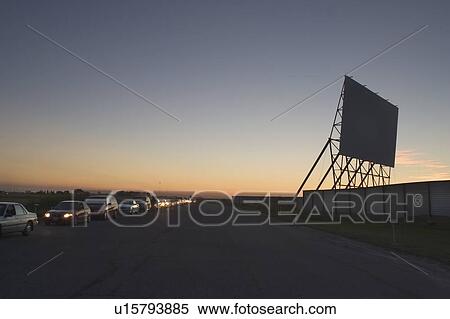 Stock Photography - Cars lined up to get into drive-in, Winnipeg, Manitoba. Fotosearch