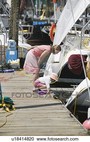 Stock Image - Caucasian Mom and 4 year old Daughter, exploring a boat dock on Granville Island. Fotosearch