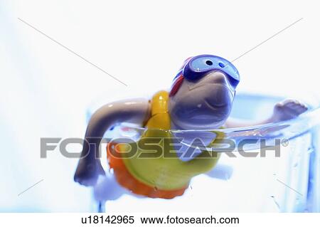 Stock Photography - Child's bathtub toy in glass of water. Fotosearch