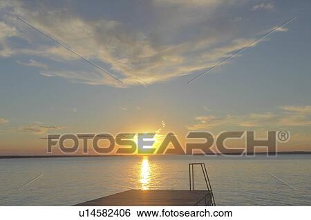Stock Photograph - Clear Lake at sunset; Canada, Manitoba, Riding Mountain National Park. Fotosearch