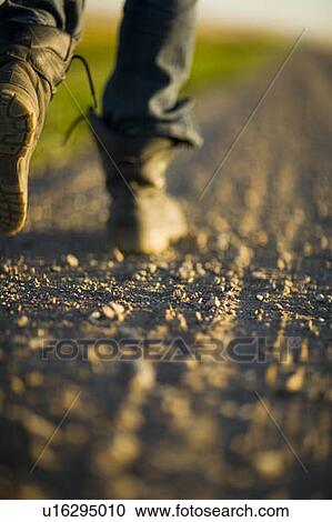 Close-up boots walking along gravelled road, rural Saskatchewan, Canada View Large Photo Image Stock Image - Close-up boots walking along gravelled road, rural Saskatchewan, Canada. Fotosearch