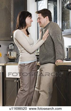 Couple in kitchen. Home has recovered/recycled cupboards and hardwood floors, Winnipeg, Canada View Large Photo Image Stock Image - Couple in kitchen. Home has recovered/recycled cupboards and hardwood floors, Winnipeg, Canada. Fotosearch