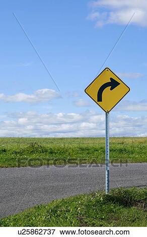 Stock Photo - Curve ahead sign on country road.. Fotosearch