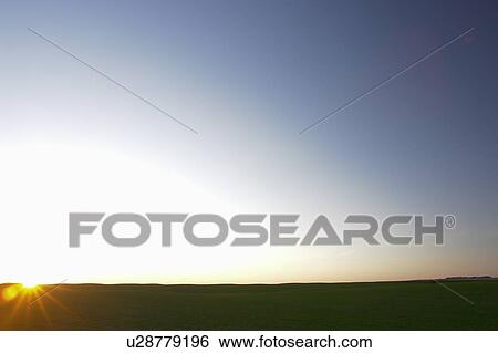 Dawn breaks over lush green field; Canada, Manitoba, Erickson View Large Photo Image Stock Photograph - Dawn breaks over lush green field; Canada, Manitoba, Erickson. Fotosearch
