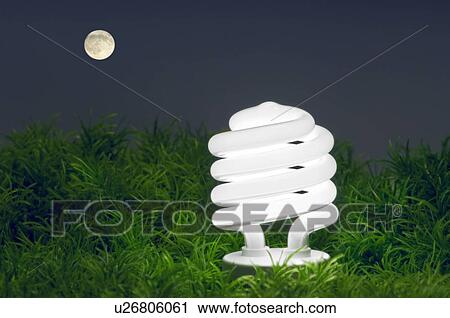 Stock Image - Energy-saving light bulb and full moon.. Fotosearch