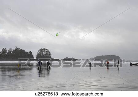 Family on beach flying a kite in winter, Long Beach, Pacific Rim National Park, British Columbia, Canada View Large Photo Image Stock Photo - Family on beach flying a kite in winter, Long Beach, Pacific Rim National Park, British Columbia, Canada. Fotosearch