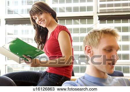 Female student looking at notebook, male student foreground, in fron of solar panelled windows, Winnipeg, Canada View Large Photo Image Stock Image - Female student looking at notebook, male student foreground, in fron of solar panelled windows, Winnipeg, Canada . Fotosearch