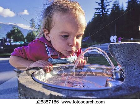 Girl, 3, drinks fresh water from fountain, Whistler, B. C. View Large Photo Image Stock Photograph - Girl, 3, drinks fresh water from fountain, Whistler, B. C.. Fotosearch