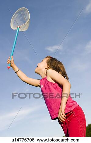 Stock Photograph - Girl - 6 years old with the net in the park, Winnipeg, Canada. Fotosearch