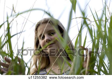 Girl in long grass, Winnipeg, Canada View Large Photo Image Stock Image - Girl in long grass, Winnipeg, Canada. Fotosearch