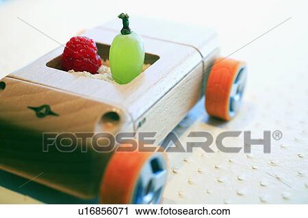 Grape and raspberry in wooden toy car View Large Photo Image Stock Image - Grape and raspberry in wooden toy car. Fotosearch