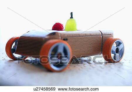 Grape and raspberry in wooden toy car View Large Photo Image Stock Photo - Grape and raspberry in wooden toy car. Fotosearch