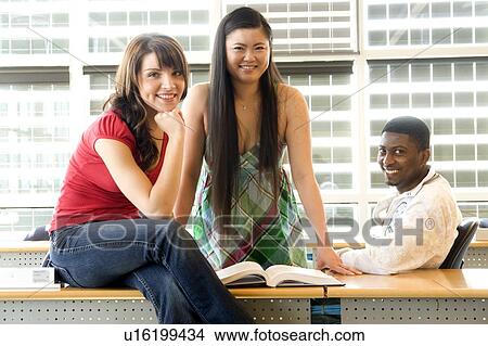 Group of 3 students seated casually in classroom, in front of solar panelled windows, Winnipeg, Canada View Large Photo Image Picture - Group of 3 students seated casually in classroom, in front of solar panelled windows, Winnipeg, Canada. Fotosearch