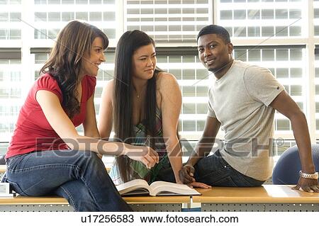 Group of 3 students seated casually in classroom, in front of solar panelled windows, Winnipeg, Canada View Large Photo Image Stock Image - Group of 3 students seated casually in classroom, in front of solar panelled windows, Winnipeg, Canada. Fotosearch