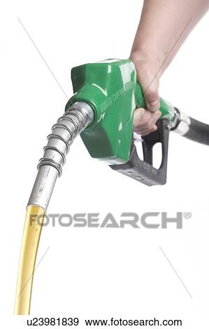 Stock Photo - Hand holds gas nozzle with gas flowing out. Fotosearch
