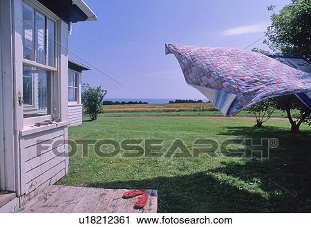 Handmade Quilt blowing on laundry line, farmhouse and ocean visible, PEI View Large Photo Image Stock Image - Handmade Quilt blowing on laundry line, farmhouse and ocean visible, PEI. Fotosearch