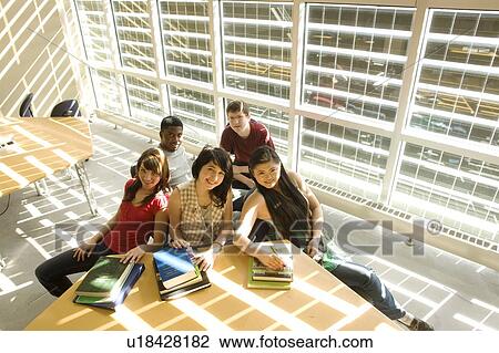High angle portrait of students seated around table in front of solar panelled windows, Winnipeg, Canada View Large Photo Image Stock Image - High angle portrait of students seated around table in front of solar panelled windows, Winnipeg, Canada. Fotosearch