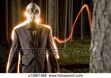 Light stream behind man wearing gas mask in nighttime forest View Large Photo Image Stock Photo - Light stream behind man wearing gas mask in nighttime forest. Fotosearch