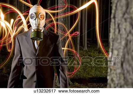 Light stream behind man wearing gas mask in nighttime forest View Large Photo Image Stock Photo - Light stream behind man wearing gas mask in nighttime forest. Fotosearch