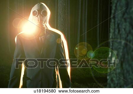 Light stream glow behind man wearing gas mask in nighttime forest View Large Photo Image Stock Image - Light stream glow behind man wearing gas mask in nighttime forest. Fotosearch