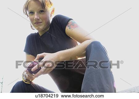 Low angle portrait of woman holding organic apple View Large Photo Image Stock Photo - Low angle portrait of woman holding organic apple. Fotosearch
