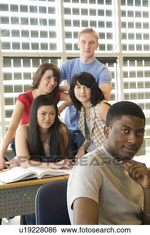 Male student foreground, group of students in background, in front of solar panelled windows, Winnipeg, Canada. View Large Photo Image Stock Photograph - Male student foreground, group of students in background, in front of solar panelled windows, Winnipeg, Canada.. Fotosearch