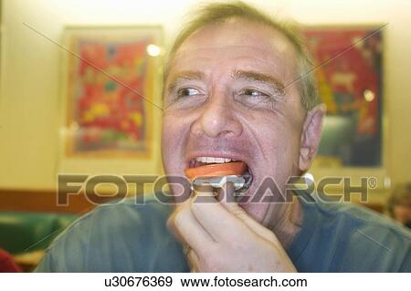 Man eating in a restaurant View Large Photo Image Stock Photo - Man eating in a restaurant. Fotosearch