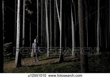 Man in forest at night wearing gas mask and carrying large briefcase View Large Photo Image Stock Image - Man in forest at night wearing gas mask and carrying large briefcase. Fotosearch