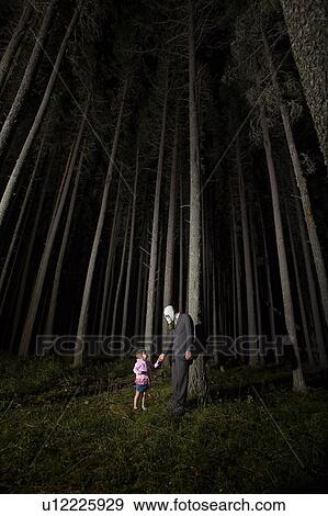 Man in Gas Mask and suit with little girl stand beside eerie trees at night, Cypress Hills, Saskatchewan View Large Photo Image Stock Photo - Man in Gas Mask and suit with little girl stand beside eerie trees at night, Cypress Hills, Saskatchewan. Fotosearch