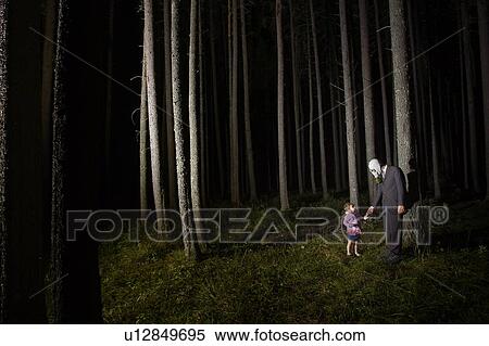 Man in Gas Mask and suit with little girl stand beside eerie trees at night, Cypress Hills, Saskatchewan View Large Photo Image Stock Photography - Man in Gas Mask and suit with little girl stand beside eerie trees at night, Cypress Hills, Saskatchewan. Fotosearch