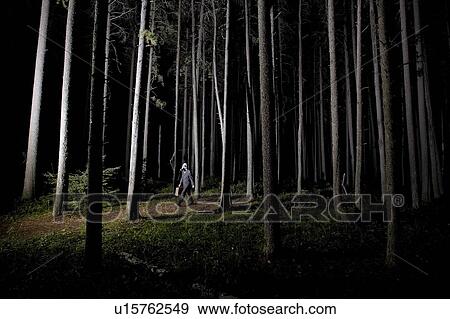Man walking in forest at night wearing gas mask and carrying large briefcase View Large Photo Image Stock Photo - Man walking in forest at night wearing gas mask and carrying large briefcase. Fotosearch