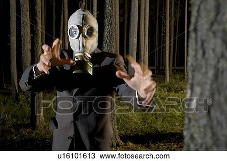 Man wearing gas mask and business suit makes threatening gesture toward camera View Large Photo Image Stock Image - Man wearing gas mask and business suit makes threatening gesture toward camera. Fotosearch