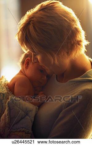 Mother cuddling infant View Large Photo Image Stock Image - Mother cuddling infant. Fotosearch