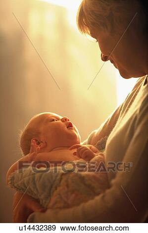 Mother holding child View Large Photo Image Stock Photo - Mother holding child. Fotosearch